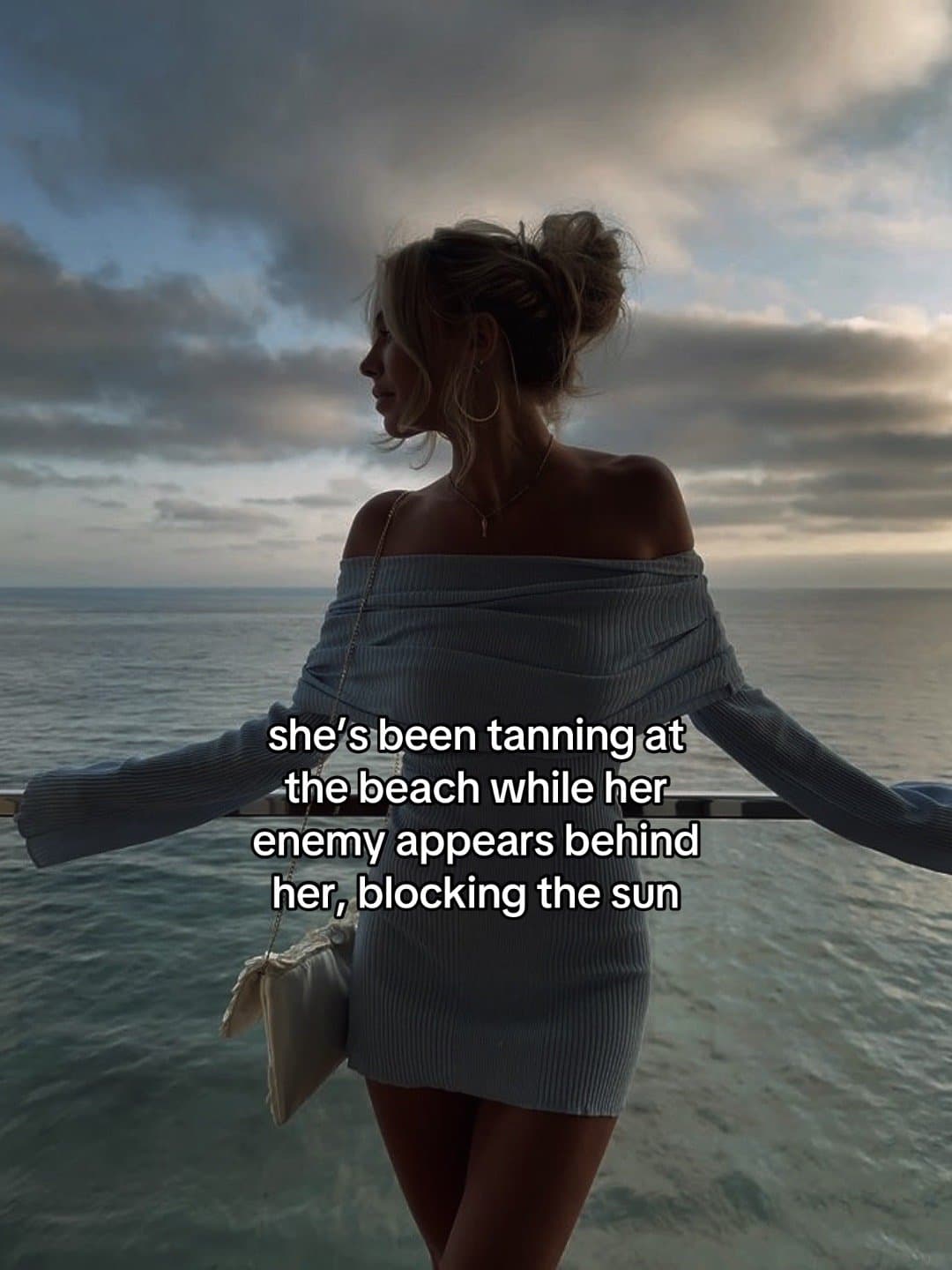 she’s been tanning at the beach while her enemy appears behind her, blocking the…